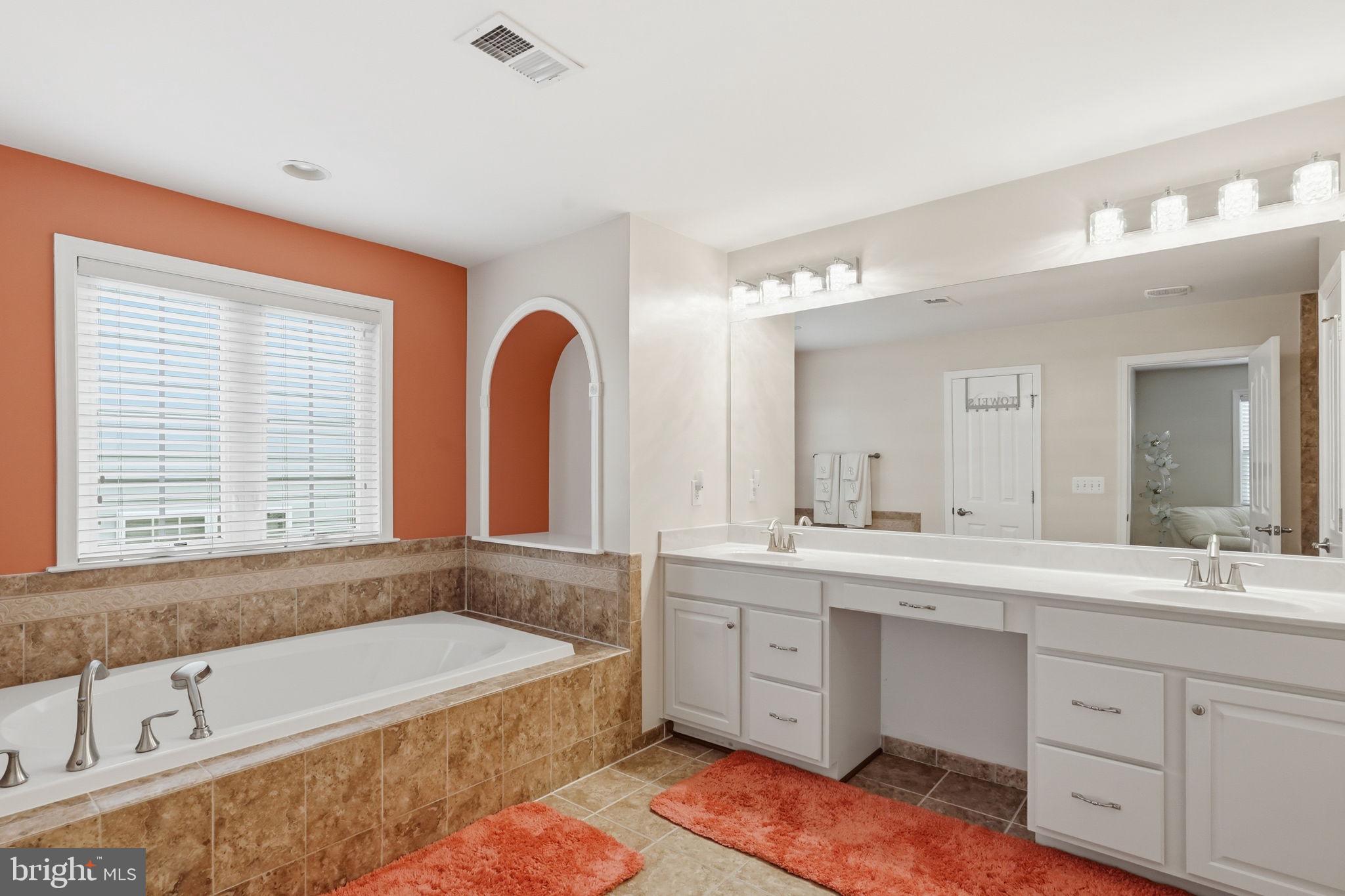 14 Smelters Trace Road Stafford, VA 22554 - Photo 38 of 78 a bathroom with a bathtub a double vanity sink a window a mirror and