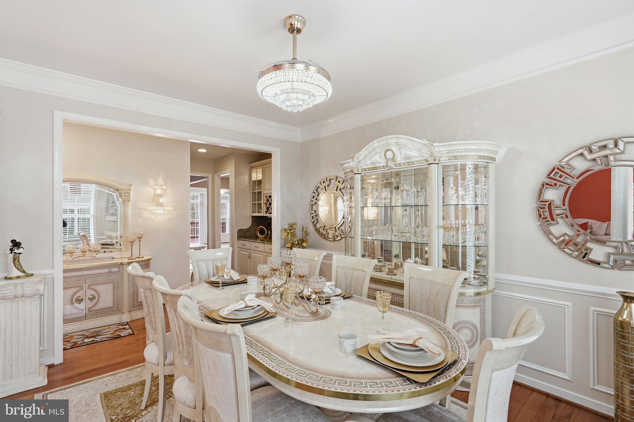 14 Smelters Trace Road Stafford, VA 22554 - Photo 4 of 78 a dining room with wooden floor a chandelier a wooden table and chairs