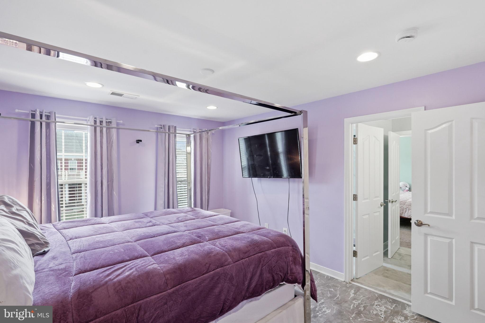 14 Smelters Trace Road Stafford, VA 22554 - Photo 53 of 78 a bedroom with a large bed a flat tv screen and a walk in closet