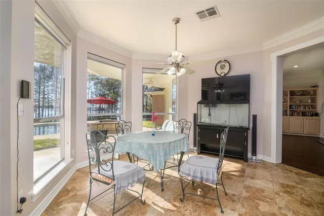 a dining room with furniture a fireplace and chandelier