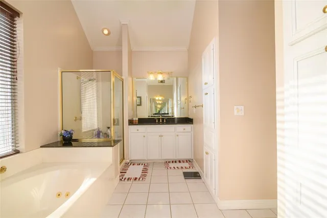 a bathroom with a tub sink and mirror