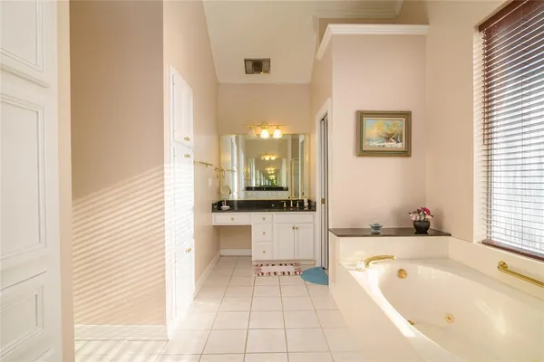 a bathroom with a tub a sink and a large mirror