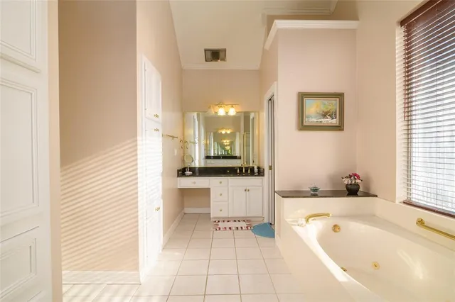 a bathroom with a tub a sink and a large mirror