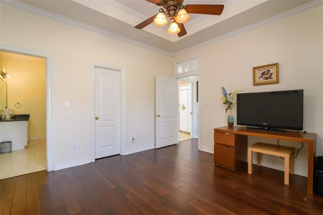 a view of a livingroom with wooden floor and a flat screen tv