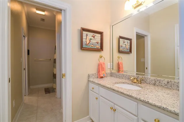 a bathroom with a granite countertop sink mirror and vanity