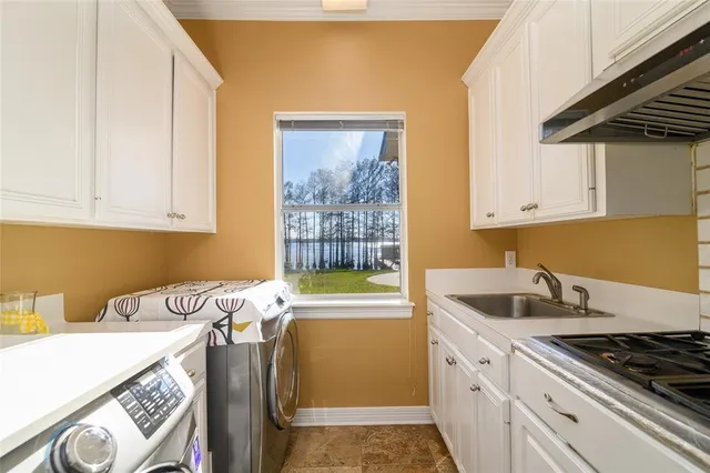a kitchen with stainless steel appliances granite countertop a sink stove and cabinets