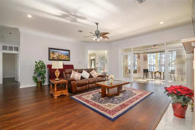a living room with furniture and a chandelier
