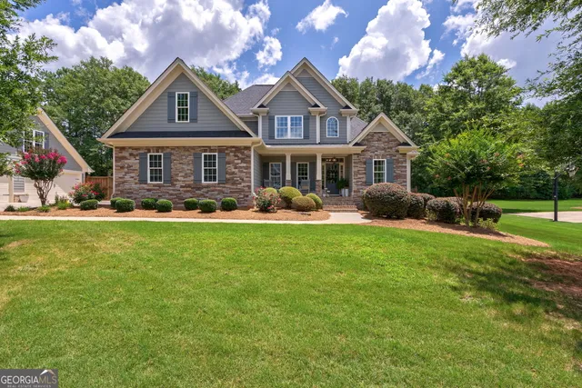 a front view of a house with garden