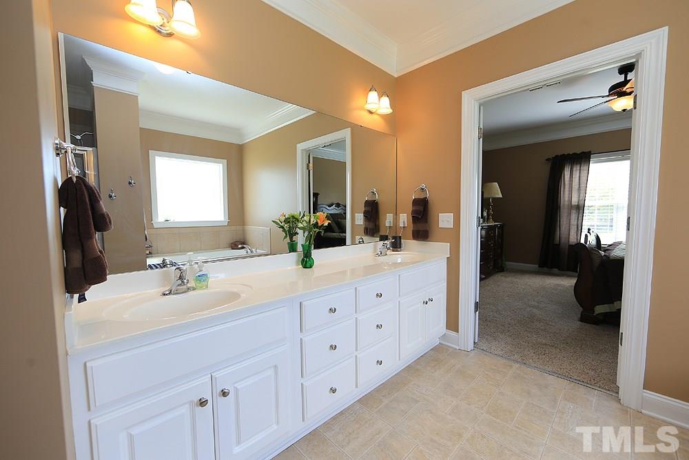 214 Steve Ridge Willow Spring, NC 27592 - Photo 16 of 29 a bathroom with double sink and a mirror