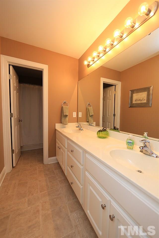 214 Steve Ridge Willow Spring, NC 27592 - Photo 20 of 29 a bathroom with a double vanity sink and a mirror
