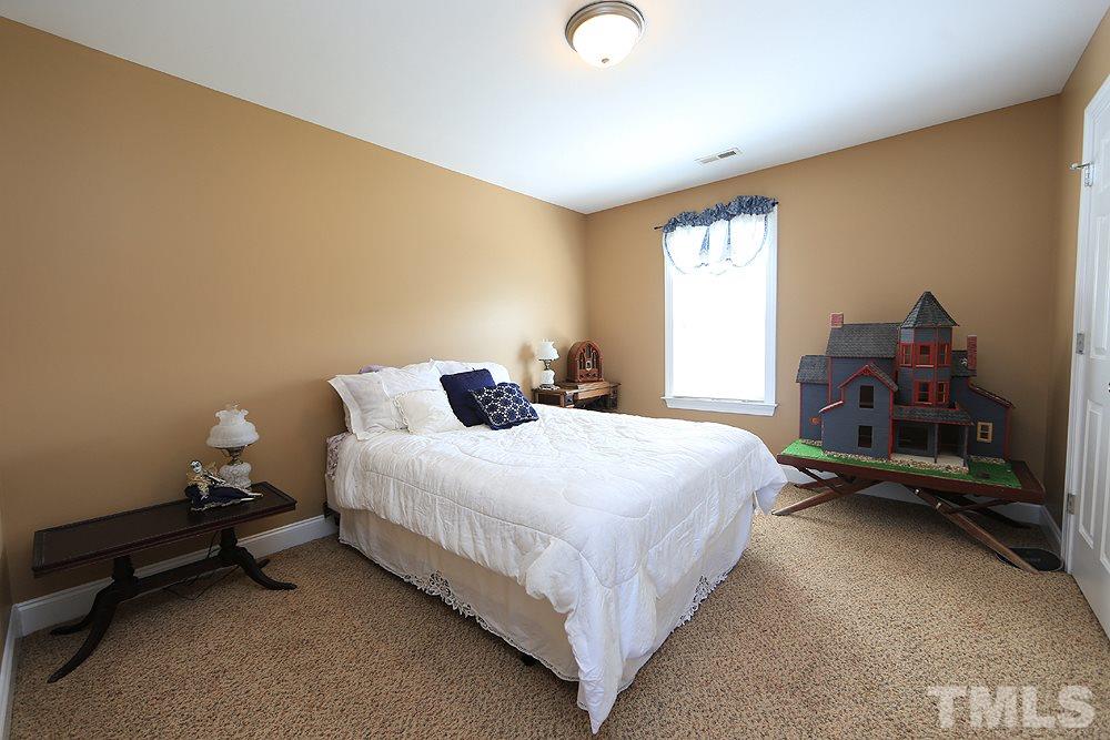 214 Steve Ridge Willow Spring, NC 27592 - Photo 21 of 29 a bedroom with a bed and a window