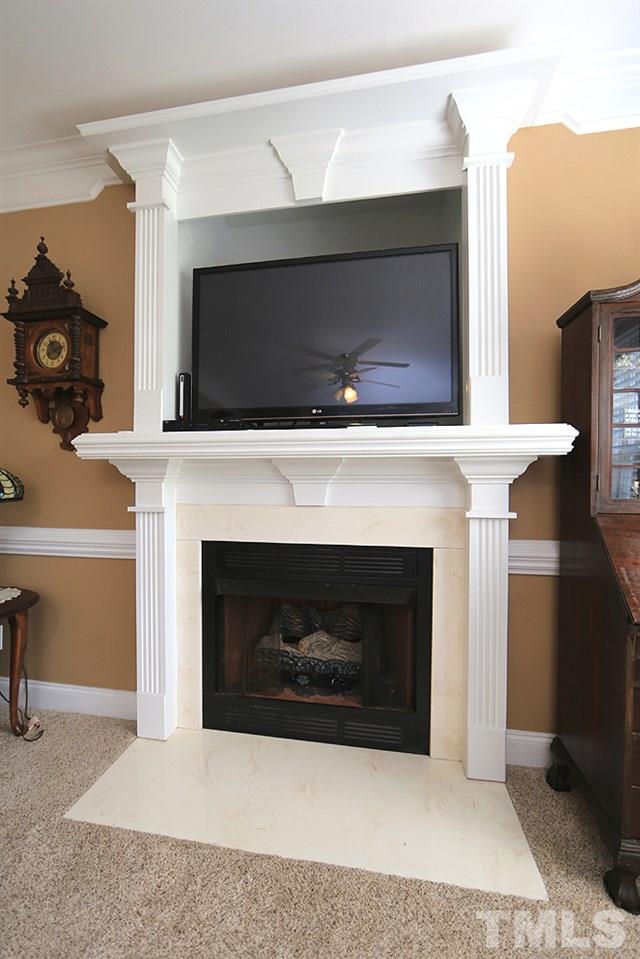 214 Steve Ridge Willow Spring, NC 27592 - Photo 8 of 29 a living room with a fireplace a rug and a fireplace