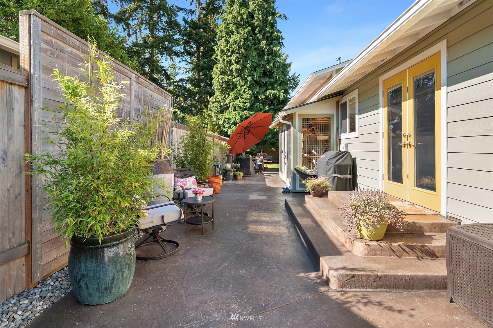 127 Hoquiam Avenue Southeast Renton, WA 98059 - Photo 20 of 26 a view of a patio with couches and table and chairs and potted plants