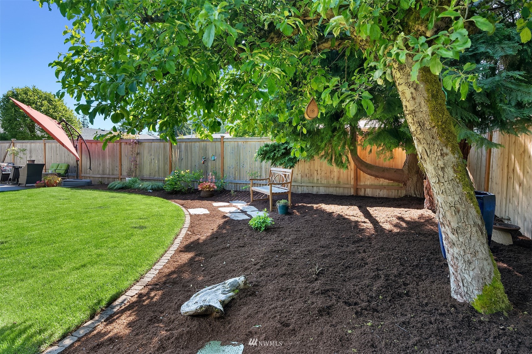 127 Hoquiam Avenue Southeast Renton, WA 98059 - Photo 25 of 26 a view of backyard with table and chairs a barbeque and a large trees with a swing