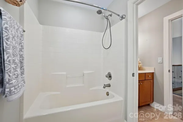 a spacious bathroom with a toilet a sink and a mirror