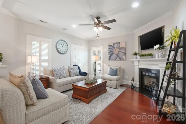 a living room with furniture a flat screen tv and a fireplace