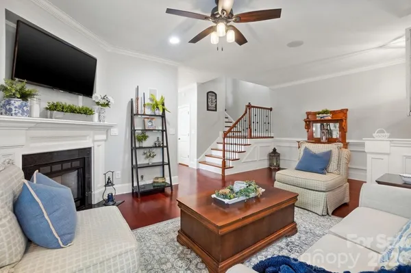a living room with furniture a rug and a window
