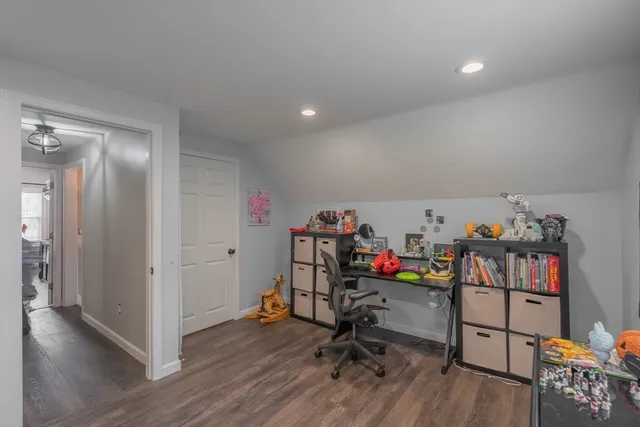 a view of a workspace with furniture and wooden floor