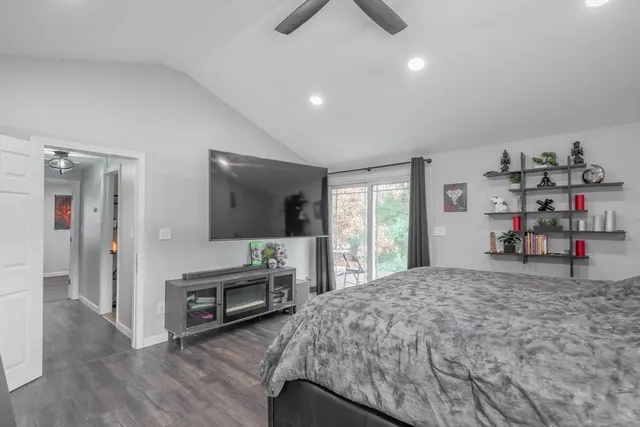 a bedroom with furniture and a flat screen tv