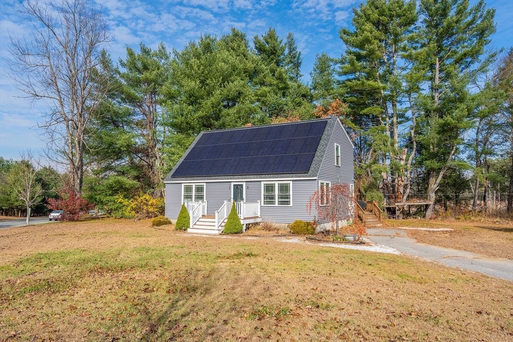 149 Dunnbrook Road East Brookfield, MA 01515 - Photo 29 of 34 a front view of a house with a yard covered with snow and trees