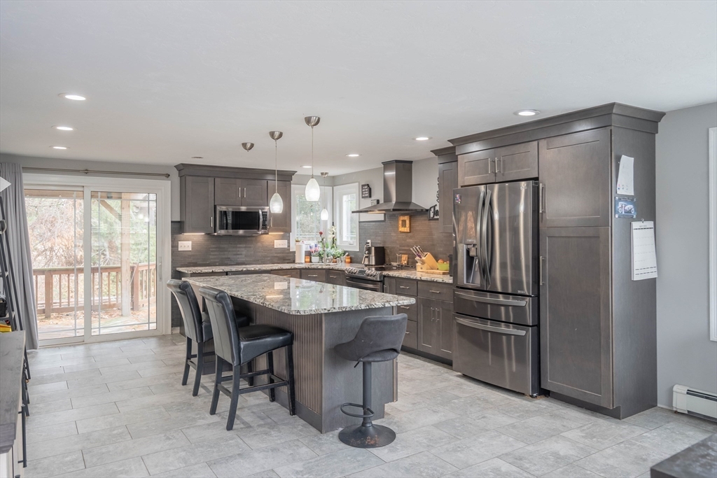 149 Dunnbrook Road East Brookfield, MA 01515 - Photo 6 of 34 a kitchen with stainless steel appliances a refrigerator a stove a sink a dining table and chairs