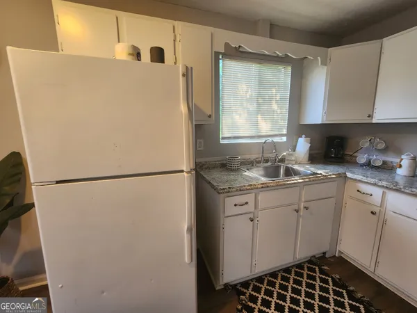 a white refrigerator freezer sitting inside of a kitchen