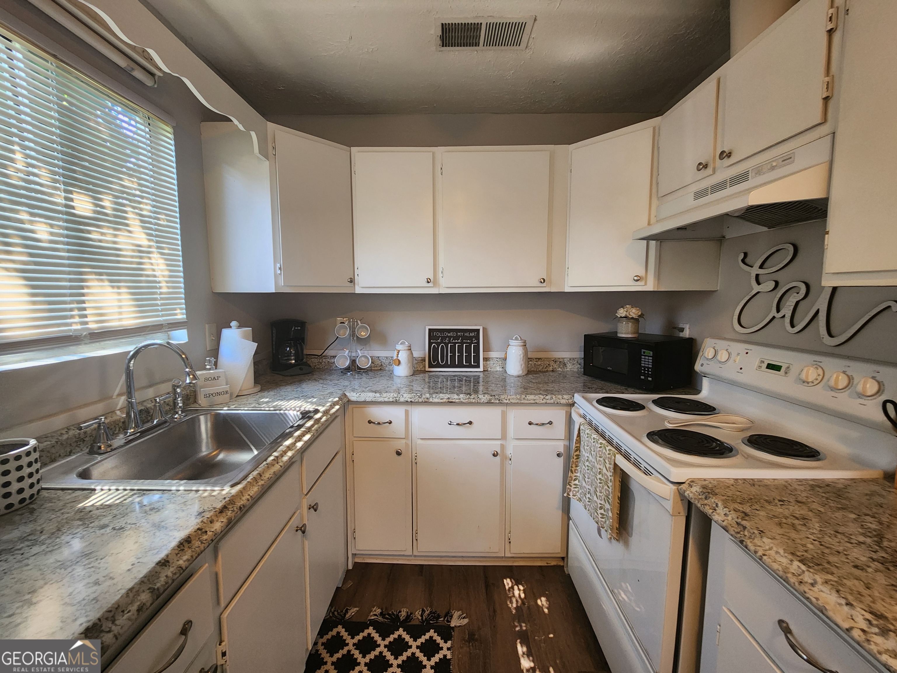 917 Oakview Avenue, Unit C Columbus, GA 31906 - Photo 12 of 14 a kitchen with granite countertop a sink a stove and cabinets