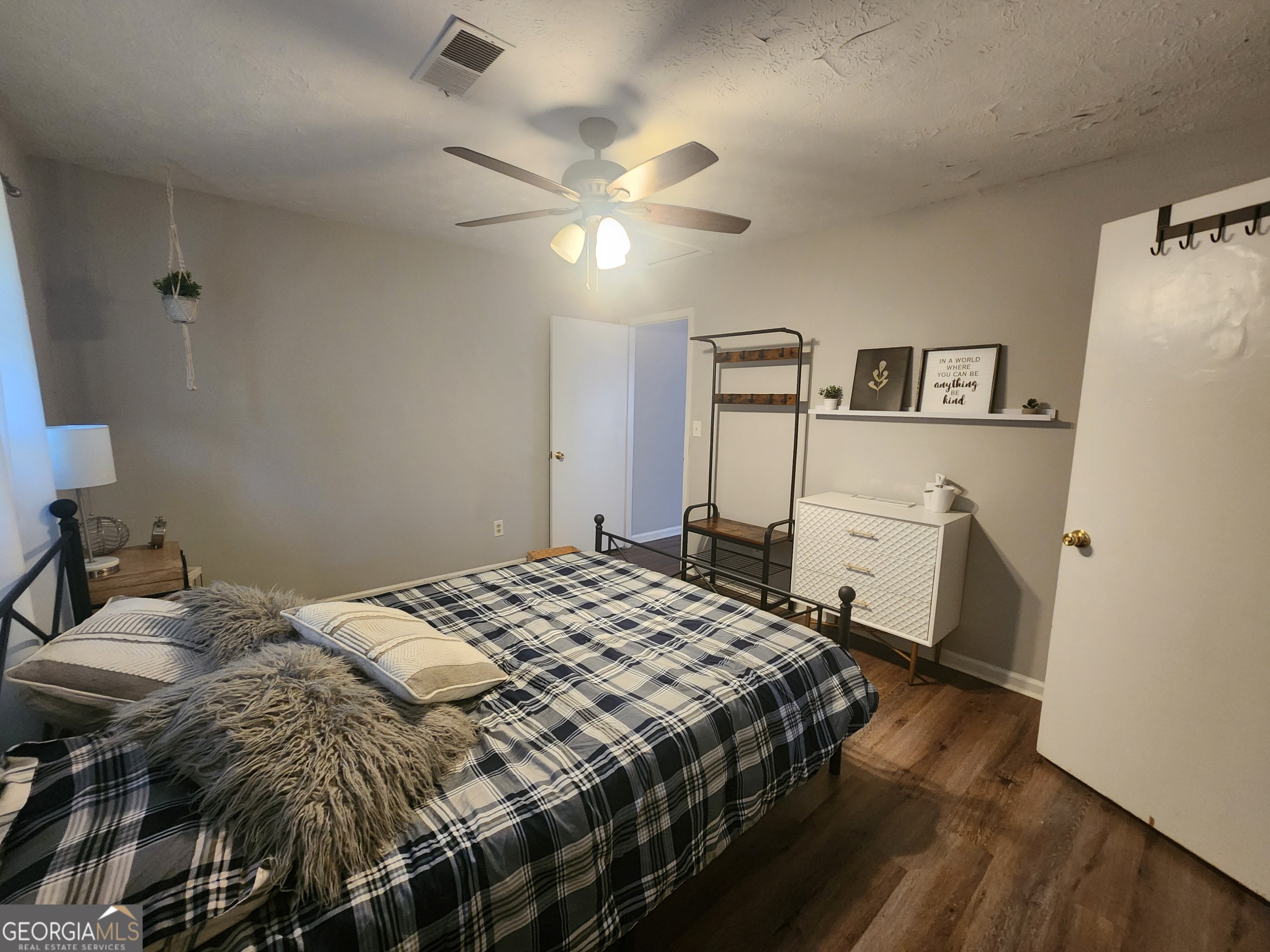 917 Oakview Avenue, Unit C Columbus, GA 31906 - Photo 5 of 14 a bedroom with a bed and a chandelier