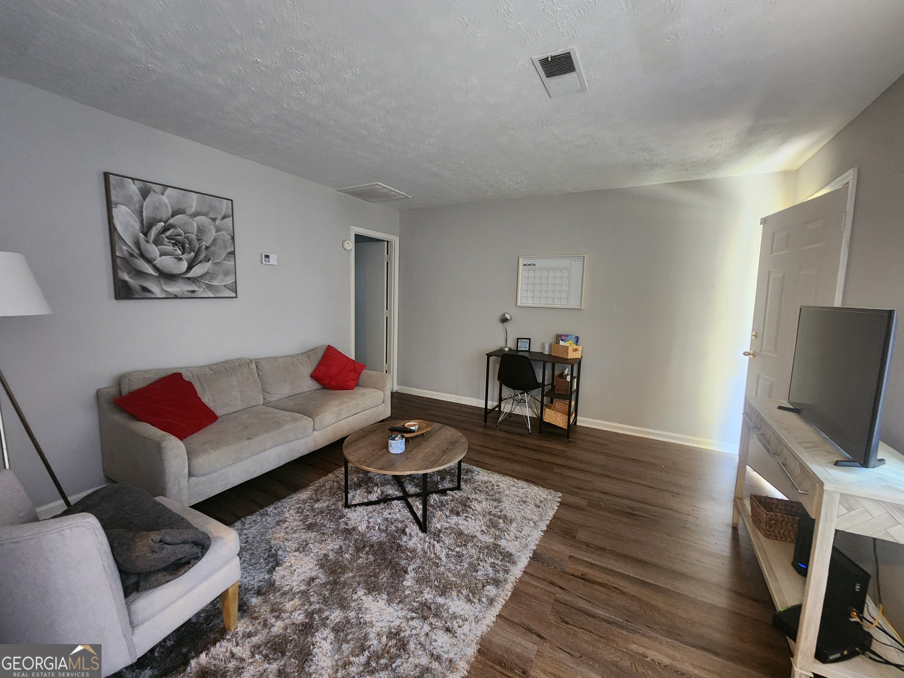 917 Oakview Avenue, Unit C Columbus, GA 31906 - Photo 8 of 14 a living room with furniture and a flat screen tv