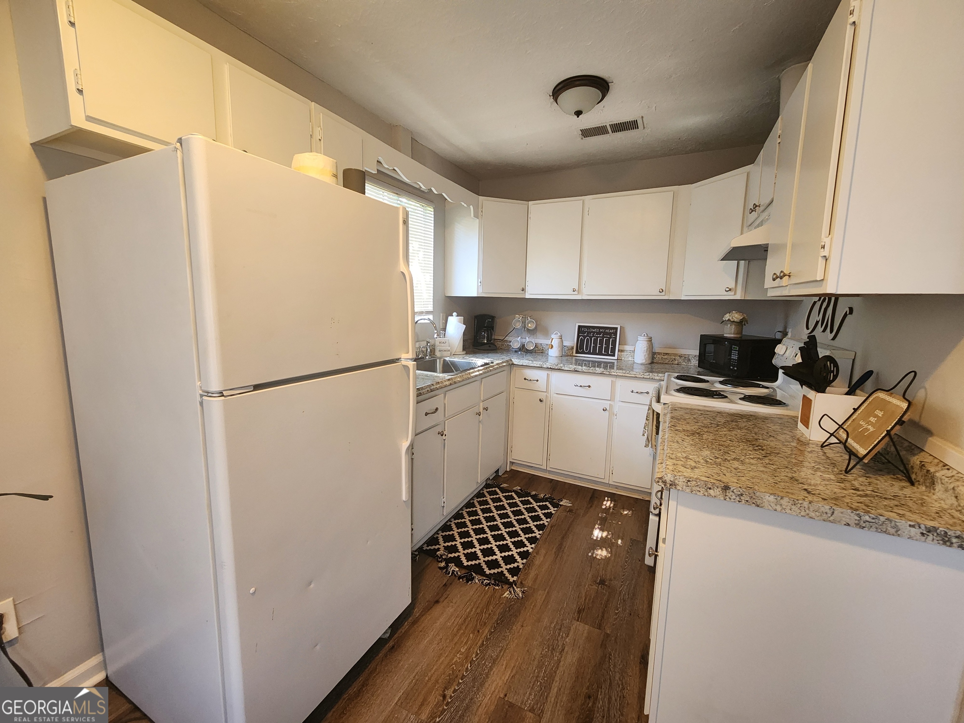 917 Oakview Avenue, Unit C Columbus, GA 31906 - Photo 10 of 14 a kitchen with a refrigerator a sink and cabinets