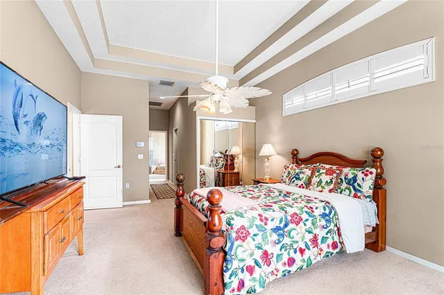 a bedroom with bed and a chandelier