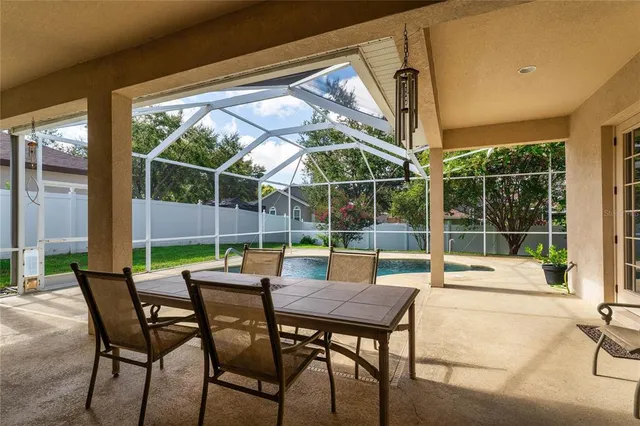 a view of a patio with a table and chairs