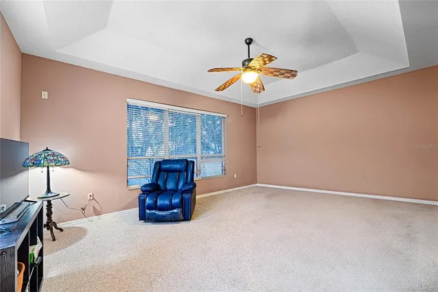 a view of an empty room with a window and a chandelier