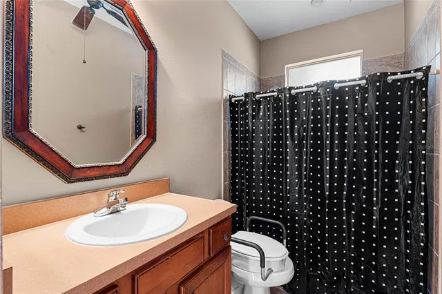 a bathroom with a sink a toilet and a mirror