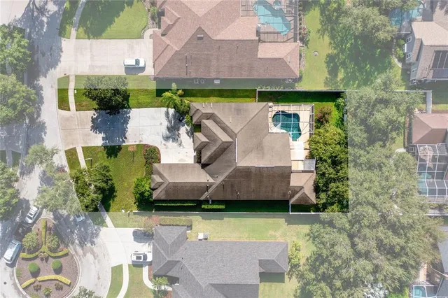 an aerial view of a house with a yard