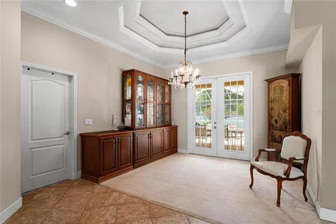 a living room with furniture and a chandelier