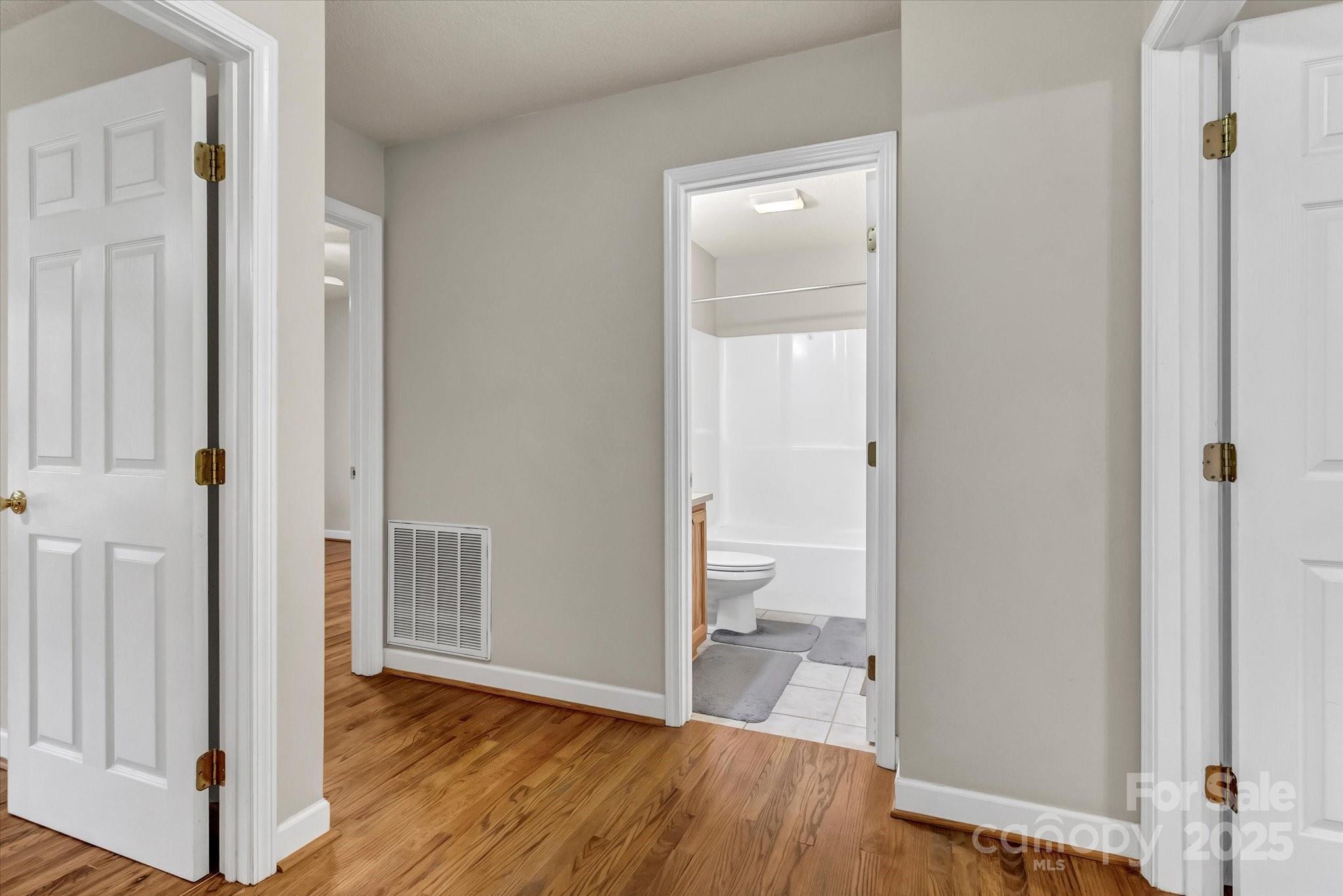 4773 Westwinds Road Lincolnton, NC 28092 - Photo 22 of 38 a view of a room with wooden floor and a bathroom view