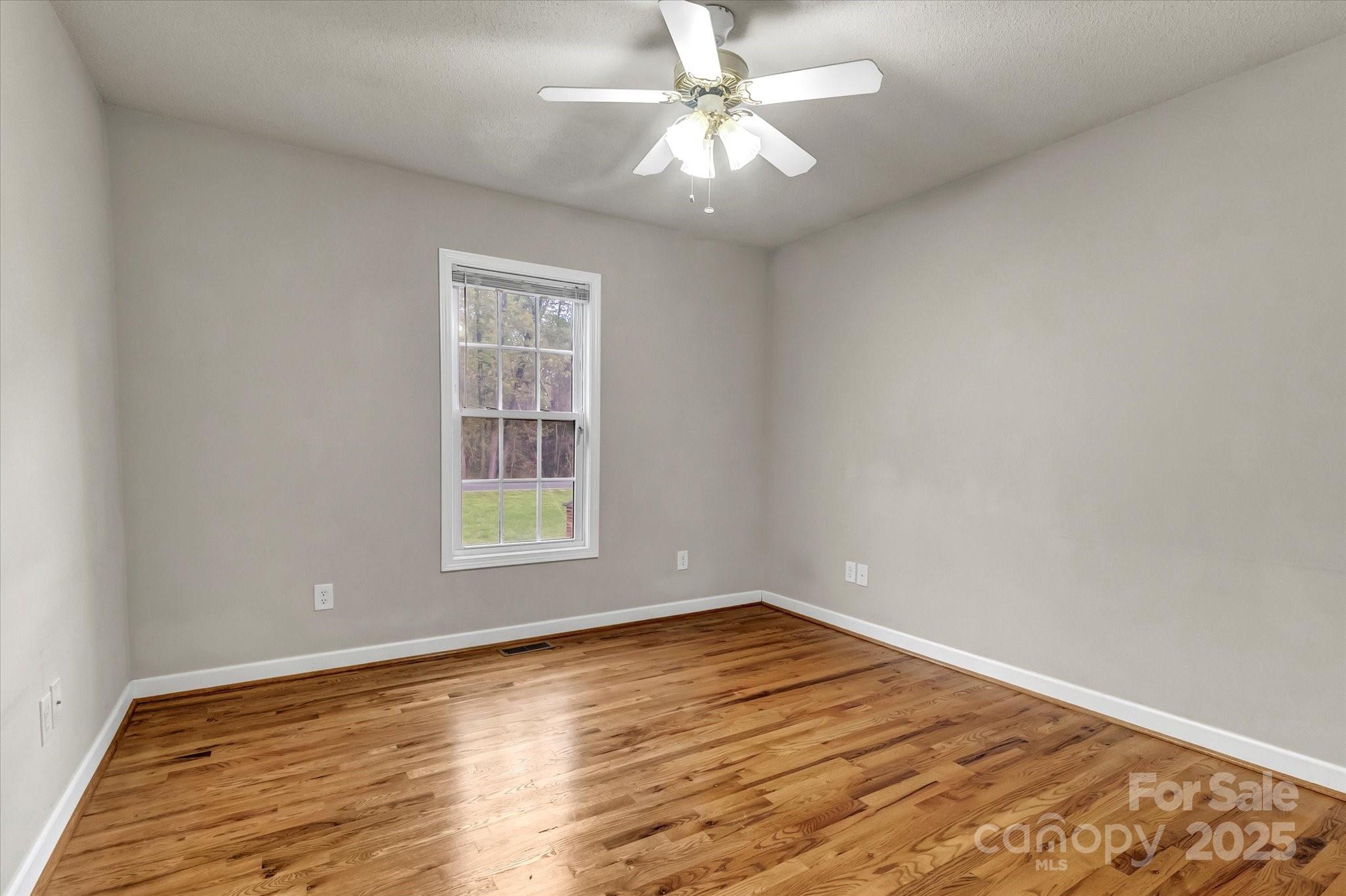 4773 Westwinds Road Lincolnton, NC 28092 - Photo 28 of 38 wooden floor in an empty room with a window