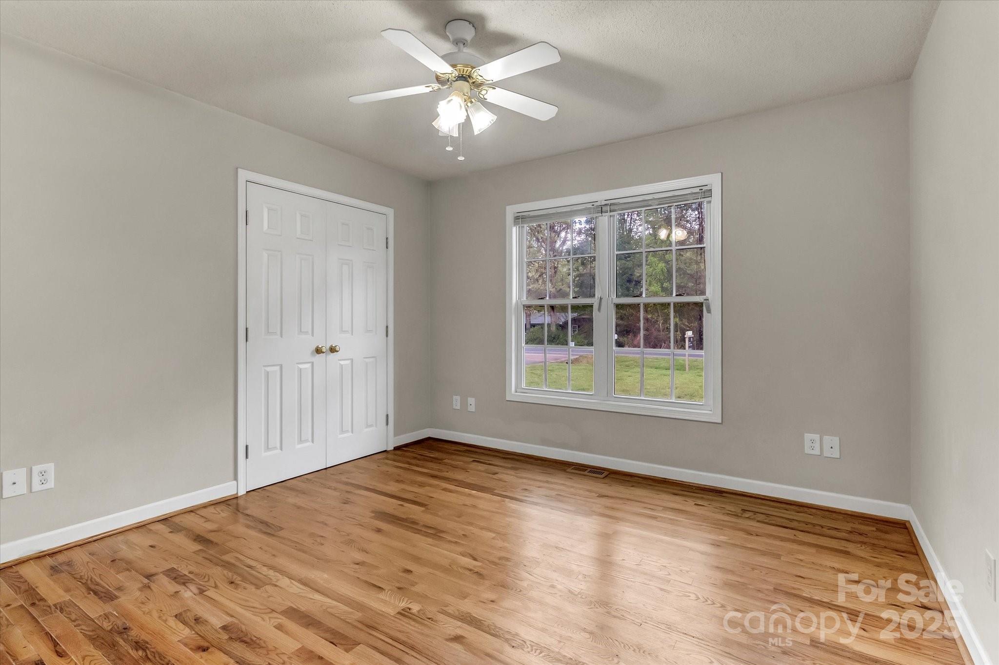 4773 Westwinds Road Lincolnton, NC 28092 - Photo 30 of 38 a view of empty room with wooden floor and fan