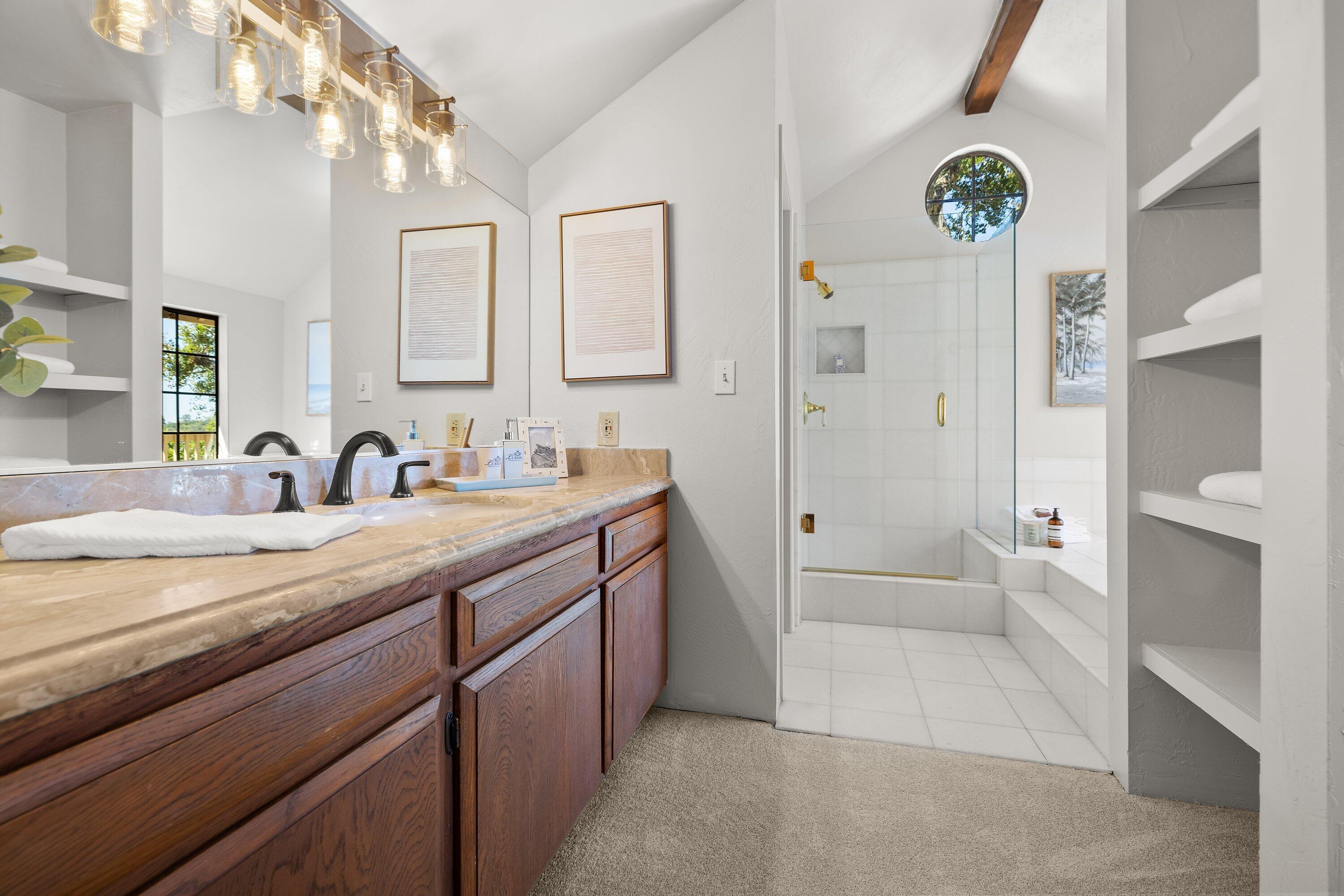 844 Cheltenham Road Santa Barbara, CA 93105 - Photo 23 of 31 a spacious bathroom with a granite countertop sink a mirror and a shower
