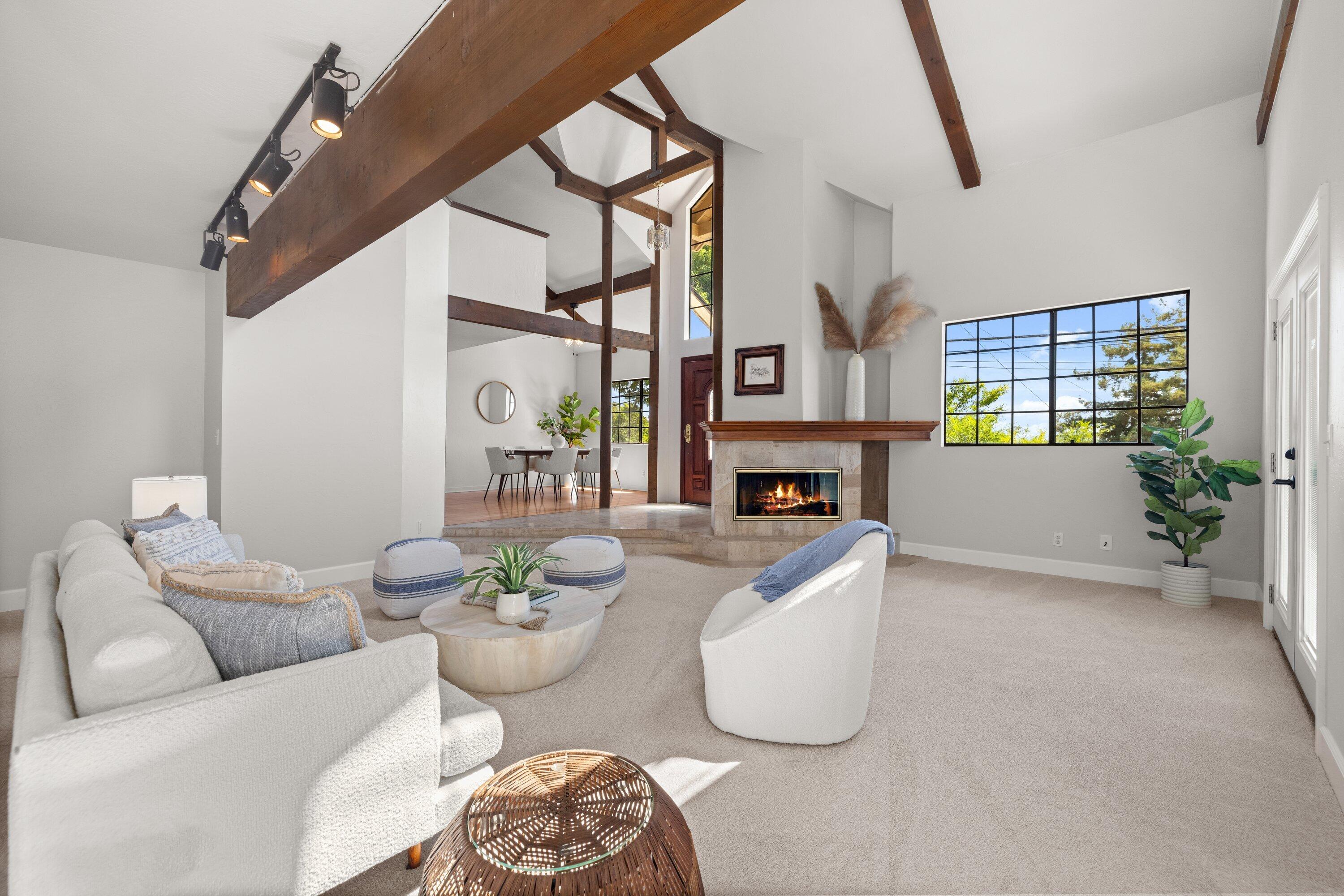 844 Cheltenham Road Santa Barbara, CA 93105 - Photo 5 of 31 a living room with furniture a fireplace and a table