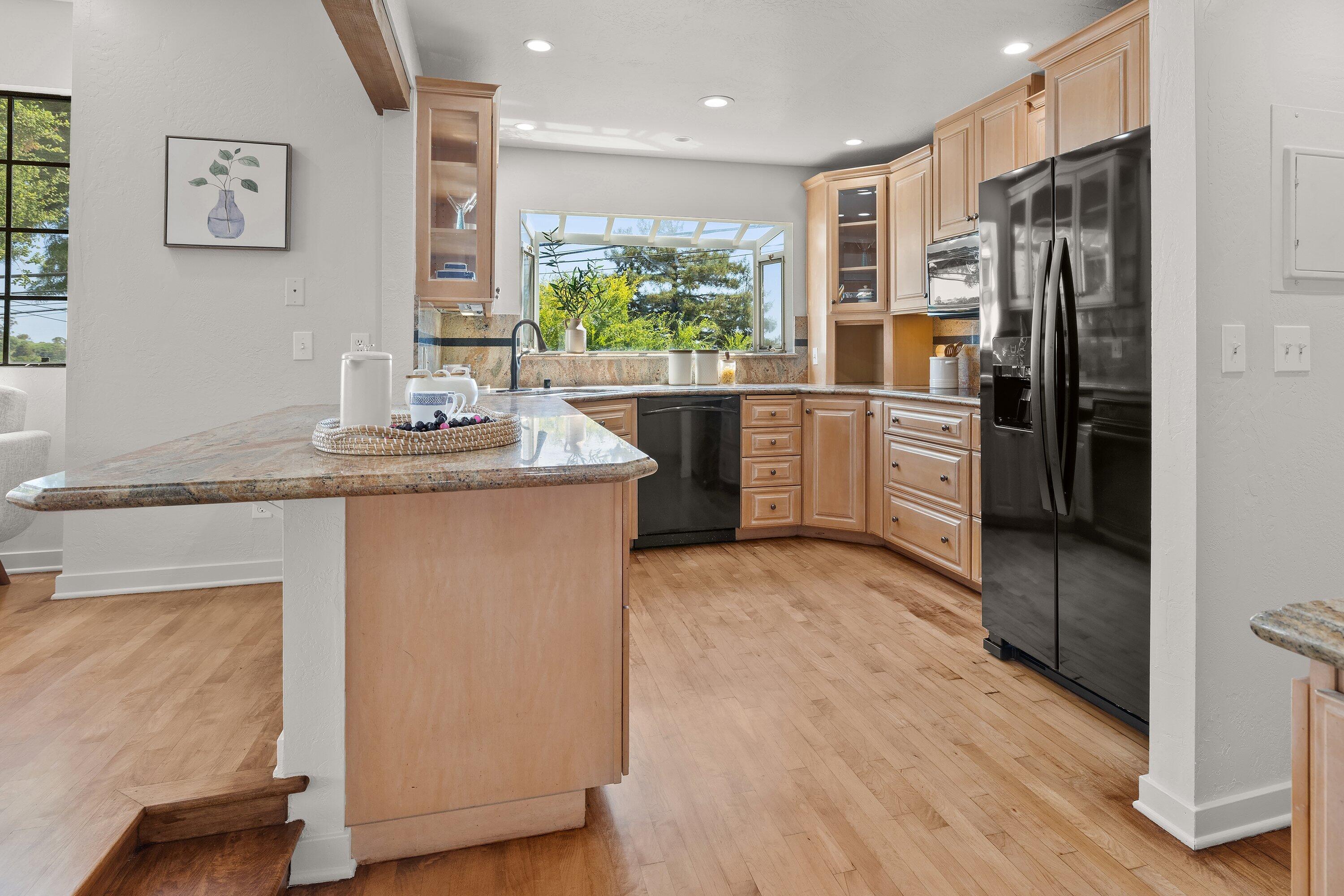 844 Cheltenham Road Santa Barbara, CA 93105 - Photo 7 of 31 a kitchen with stainless steel appliances granite countertop a refrigerator a sink and a stove