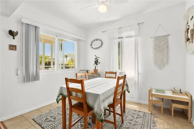 a view of a dining room with furniture and a chandelier