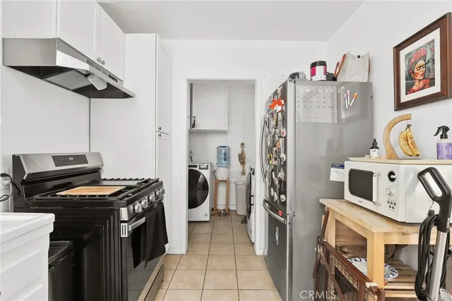 a bedroom with two beds and a flat screen tv