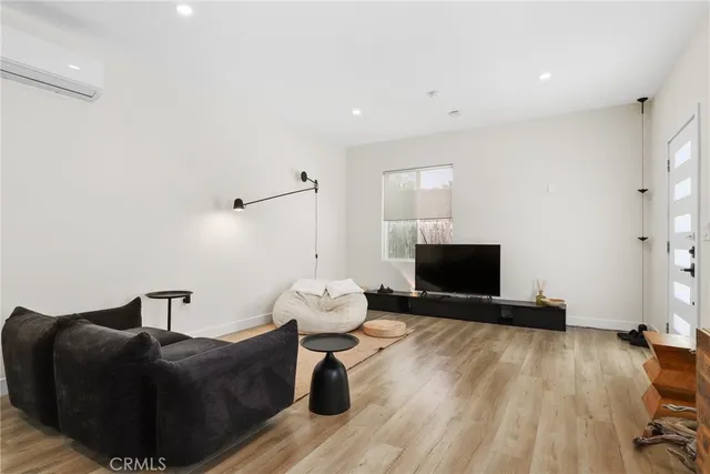 a living room with furniture and kitchen view