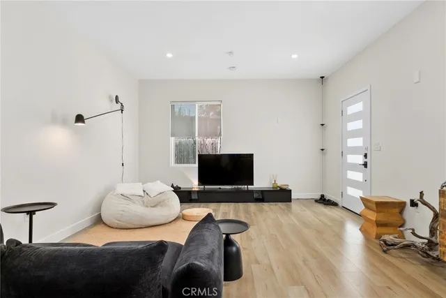 a kitchen with stainless steel appliances granite countertop a sink a stove a refrigerator and cabinets