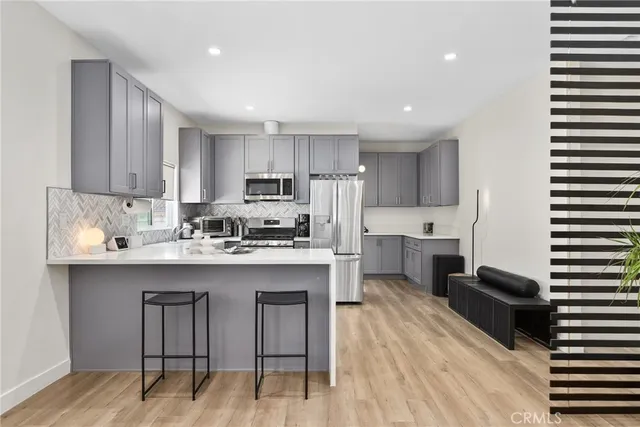 a kitchen with cabinets and stainless steel appliances