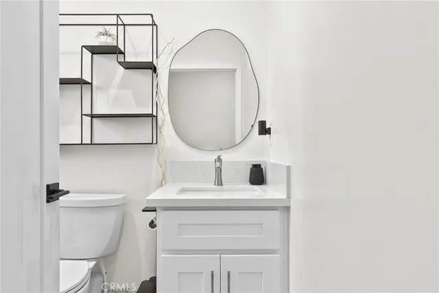 a bedroom with a bed mirror and window