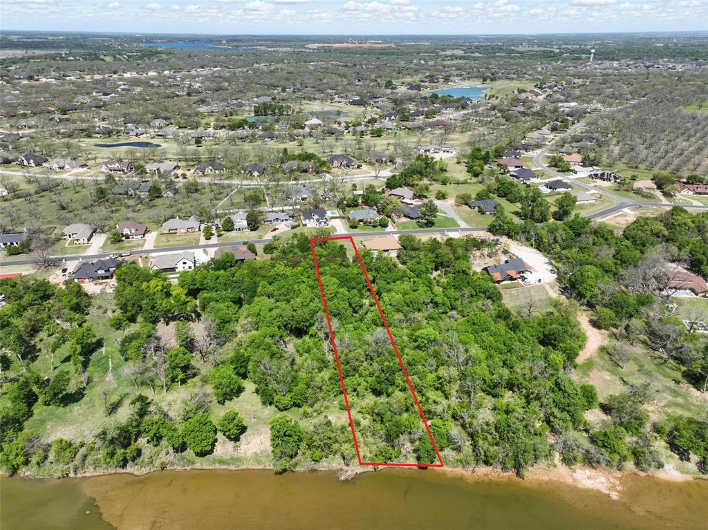 9804 Bellechase Road Granbury, TX 76049 - Photo 14 of 18 Elevated aerial view capturing river frontage and lush canopy of trees.