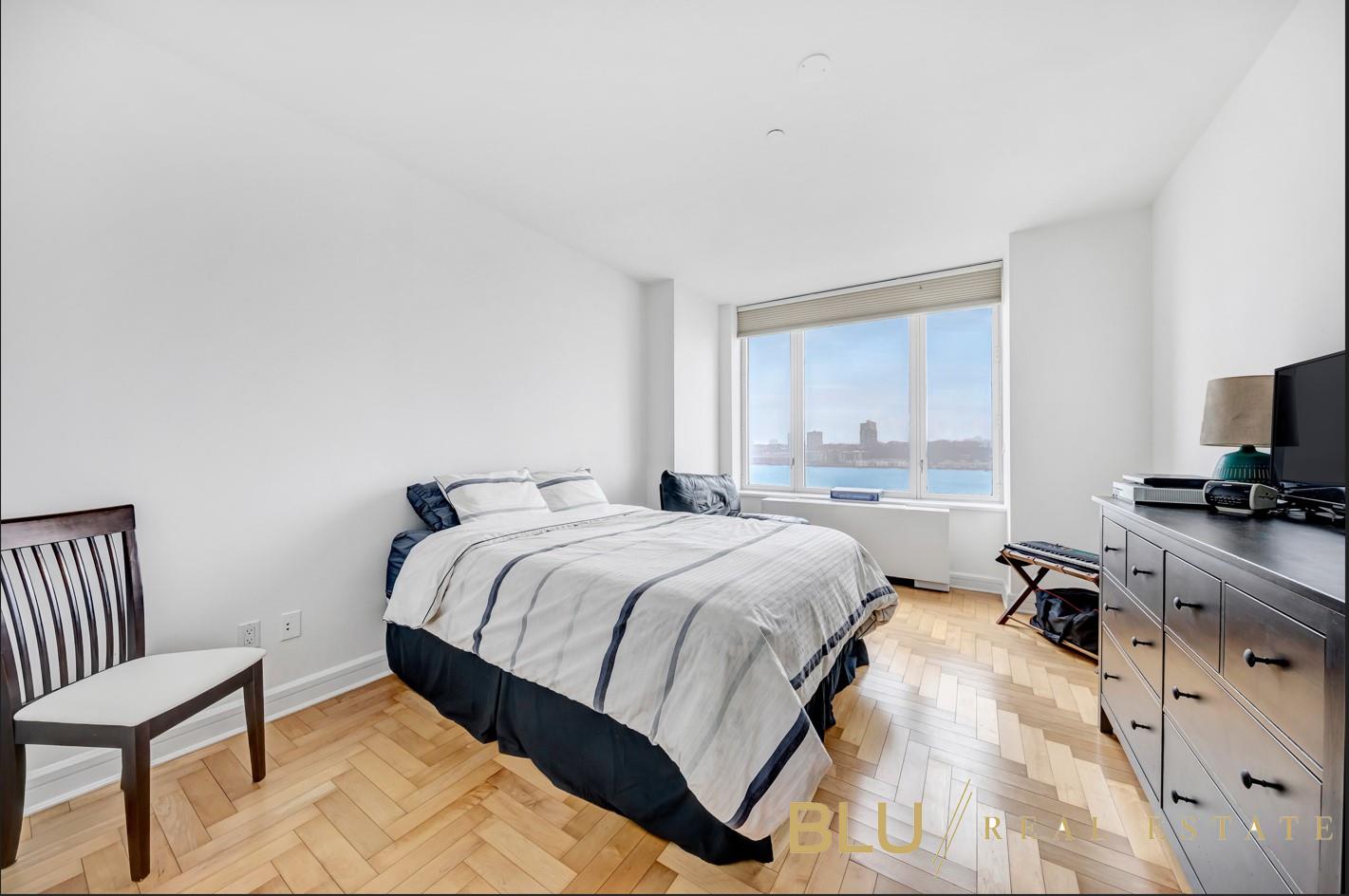 220 Riverside Boulevard, Unit 15M Manhattan, NY 10069 - Photo 9 of 11 a bedroom with a bed and a tv on the dresser